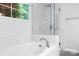 Luxurious bathroom with a soaking tub, a glass-enclosed shower, and marble tile at 5400 Groveton Ct, Charlotte, NC 28269