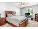 Comfortable bedroom with wooden bed frame, ceiling fan, and sunny window perfect for a good night's sleep at 5400 Groveton Ct, Charlotte, NC 28269