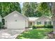 Charming single-story home with an attached two-car garage and a well-manicured front yard at 5400 Groveton Ct, Charlotte, NC 28269