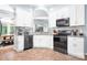 Modern kitchen with sleek stainless steel appliances, white cabinetry, and stylish gray backsplash at 5400 Groveton Ct, Charlotte, NC 28269