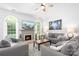 Bright living room featuring a cozy fireplace, ceiling fan and multiple sofas for relaxing or entertaining at 5400 Groveton Ct, Charlotte, NC 28269
