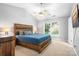 Comfortable bedroom with a vaulted ceiling, ceiling fan, plush carpeting, and a large window at 5400 Groveton Ct, Charlotte, NC 28269