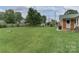 Spacious backyard featuring a well-maintained lawn, mature trees, and a privacy fence at 6206 Clearwater Dr, Indian Trail, NC 28079