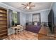 Bedroom with wood-look floors, ceiling fan, and a comfortable bed setup at 6206 Clearwater Dr, Indian Trail, NC 28079
