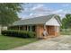 Traditional brick home with a covered front porch, landscaped lawn, and well-maintained exterior at 6206 Clearwater Dr, Indian Trail, NC 28079
