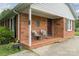 Inviting brick front porch with comfortable seating, tasteful decor, and a welcoming entrance at 6206 Clearwater Dr, Indian Trail, NC 28079