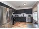 Modern kitchen features stainless steel appliances, dark cabinets, and natural light at 6206 Clearwater Dr, Indian Trail, NC 28079
