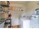 Functional laundry room with washer, dryer, and storage shelving at 6206 Clearwater Dr, Indian Trail, NC 28079