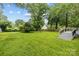 Large backyard with lush green grass and an upper and lower-level wooden deck attached to the house at 6207 Robinson Church Rd, Charlotte, NC 28215