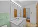 Bathroom featuring double sinks, medicine cabinet, and bright light fixture at 6207 Robinson Church Rd, Charlotte, NC 28215