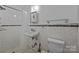 Bathroom featuring shower, sink, toilet, and neutral tile and black accent tiles at 6207 Robinson Church Rd, Charlotte, NC 28215