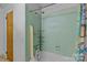 Bathroom featuring green tile and a shower/tub combination at 6207 Robinson Church Rd, Charlotte, NC 28215