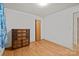 Bedroom featuring hardwood floors with a dresser and a door leading to another room at 6207 Robinson Church Rd, Charlotte, NC 28215