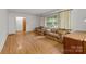 Cozy living room with hardwood floors, natural light, and comfortable seating arrangement at 6207 Robinson Church Rd, Charlotte, NC 28215