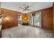 Living room featuring wood paneling, access to the deck, and view of the yard at 6207 Robinson Church Rd, Charlotte, NC 28215