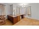 Home office space featuring hardwood floors, a large desk, and traditional-style curtains at 6207 Robinson Church Rd, Charlotte, NC 28215