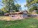 Spacious backyard with a small patio, offering plenty of room for outdoor activities and relaxation at 6208 Charlie Walker Rd, Kannapolis, NC 28081
