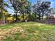 Large, level backyard with wooden fence and green grass at 6208 Charlie Walker Rd, Kannapolis, NC 28081