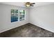 Neutral bedroom with ceiling fan and double windows offering natural light at 6208 Charlie Walker Rd, Kannapolis, NC 28081