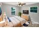 Well-lit bedroom with comfortable bed, modern dresser, and windows offering scenic views at 6208 Charlie Walker Rd, Kannapolis, NC 28081