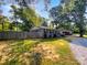 Cozy single-story home featuring a charming gray brick facade, complemented by black shutters and a well-maintained lawn at 6208 Charlie Walker Rd, Kannapolis, NC 28081