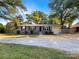 Charming home with a gravel driveway, complemented by lush trees, offering a welcoming curb appeal at 6208 Charlie Walker Rd, Kannapolis, NC 28081