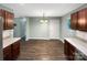 Eat in kitchen featuring wood cabinets and hardwood floors at 6208 Charlie Walker Rd, Kannapolis, NC 28081