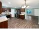 Spacious kitchen with stainless steel appliances, dark cabinets, and new flooring, perfect for cooking at 6208 Charlie Walker Rd, Kannapolis, NC 28081