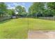 Expansive backyard featuring mature trees, a storage shed, and ample space for recreation and relaxation at 706 Hammermill Ct, Charlotte, NC 28270