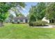Charming home featuring a well-manicured front lawn, mature trees, and tasteful landscaping at 706 Hammermill Ct, Charlotte, NC 28270