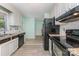 Well-lit kitchen features granite countertops, stainless steel appliances, and white cabinets at 706 Hammermill Ct, Charlotte, NC 28270