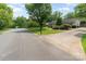 Quiet neighborhood street with well-maintained lawns and landscaping leading to a charming single-Gathering home at 706 Hammermill Ct, Charlotte, NC 28270