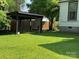 Spacious backyard featuring a wooden pergola, manicured lawn, and privacy fence at 714 E Dunlap St, Lancaster, SC 29720