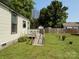 Backyard featuring a ramp leading up to a white deck, a well-manicured lawn, and potted plants at 714 E Dunlap St, Lancaster, SC 29720