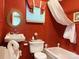 Red bathroom features a swan sink, toilet, and tub at 714 E Dunlap St, Lancaster, SC 29720