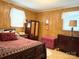 Cozy bedroom with paneled walls, classic wood furniture, and a comfortable bed at 714 E Dunlap St, Lancaster, SC 29720