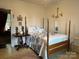 Bedroom features a four-poster bed with blue and white bedding at 714 E Dunlap St, Lancaster, SC 29720