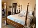 Bedroom features a four-poster bed with blue and white bedding at 714 E Dunlap St, Lancaster, SC 29720