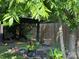 View of the wooden carport surrounded by lush greenery and a fenced in backyard at 714 E Dunlap St, Lancaster, SC 29720