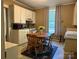 Traditional kitchen features a dining table, white cabinets, and neutral countertops at 714 E Dunlap St, Lancaster, SC 29720