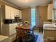 Kitchen features a vintage cabinet, wooden table, and laminate flooring at 714 E Dunlap St, Lancaster, SC 29720