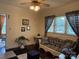 Comfortable living room with wicker seating, patterned curtains, and vintage decor at 714 E Dunlap St, Lancaster, SC 29720