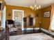 Elegant living room featuring vintage furnishings, chandelier, hardwood floors, and ample natural light at 714 E Dunlap St, Lancaster, SC 29720