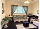 Comfortable living room with wicker seating, patterned curtains, and vintage decor at 714 E Dunlap St, Lancaster, SC 29720