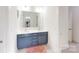 Bright bathroom features a double sink vanity with modern fixtures and light-filled doorway at 7651 Fenn Way, Fort Mill, SC 29707