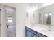 Bright bathroom features a double sink vanity with modern fixtures and an open doorway to the bedroom at 7651 Fenn Way, Fort Mill, SC 29707