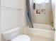 Bright bathroom features a shower and bathtub combination with gray shower curtain and tiled inset shelves at 7651 Fenn Way, Fort Mill, SC 29707
