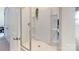 Modern bathroom features a glass shower enclosure with white tile and a door to the hallway at 7651 Fenn Way, Fort Mill, SC 29707
