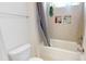 Bright bathroom features a shower and bathtub combination with gray shower curtain and tiled inset shelves at 7651 Fenn Way, Fort Mill, SC 29707
