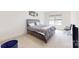 Carpeted bedroom with a queen bed, neutral walls and trim, and bright window at 7651 Fenn Way, Fort Mill, SC 29707